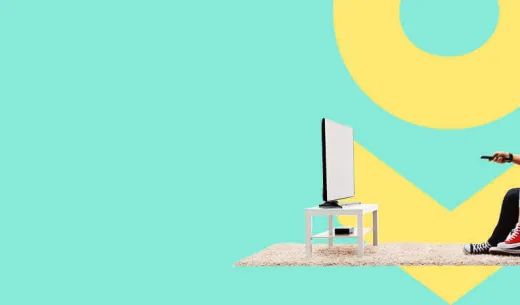 Man and woman sitting in chair watching television using satellite internet